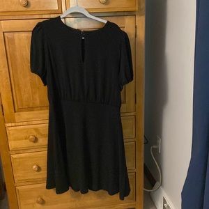 Black dress with keyhole neckline and puffed sleeves